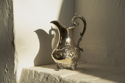 Lot 43 - A Victorian silver jug, repousse decorated...