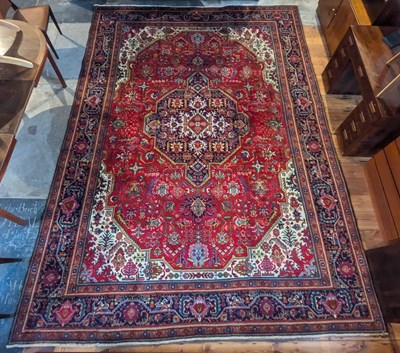 Lot 110 - A Persian Tabriz carpet, having a central...