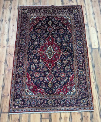 Lot 18 - A Persian Kashan rug, having a central...