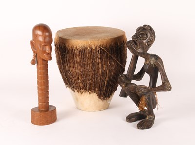 Lot 215 - An African carved wood figure, shown in...