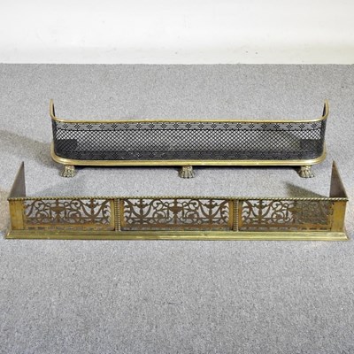 Lot 382 - A pierced brass fender, 108cm wide, together...