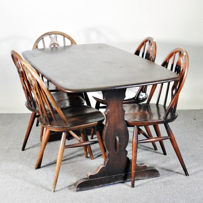 Lot 106 - A 1970's Ercol dark elm dining table, together...