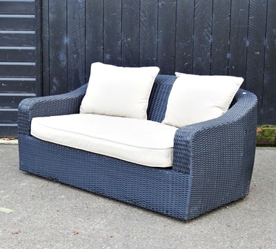 Lot 105 - A rattan garden sofa, with loose cushions