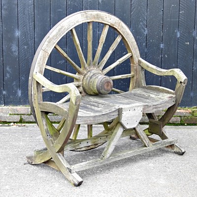 Lot 62 - A teak garden bench, with a cartwheel back