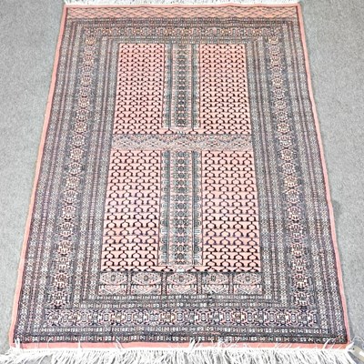 Lot 349 - A Bokhara rug on a pink ground, within...