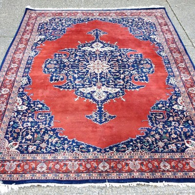 Lot 439 - A large Persian carpet, with a central...