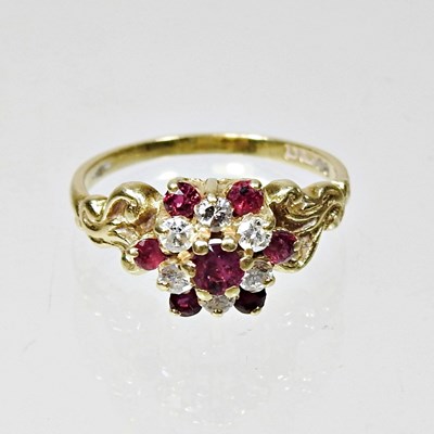 Lot 131 - An 18 carat gold diamond and ruby set cluster...