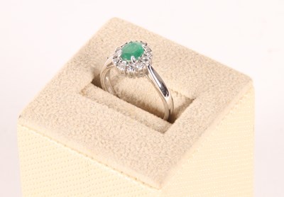 Lot 282 - An 18 carat gold diamond and emerald set...