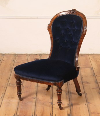 Lot 197 - A Victorian walnut nursing chair, having blue...