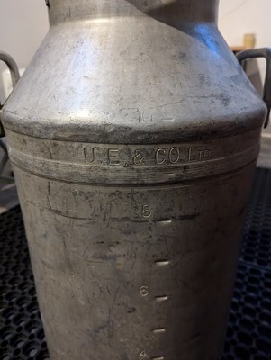 Lot 82 - A large metal milk churn, inscribed...