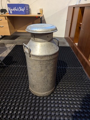 Lot 82 - A large metal milk churn, inscribed...