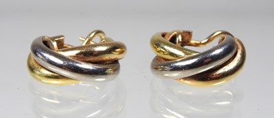 Lot 449 - A pair of Cartier 18 carat Trinity three...