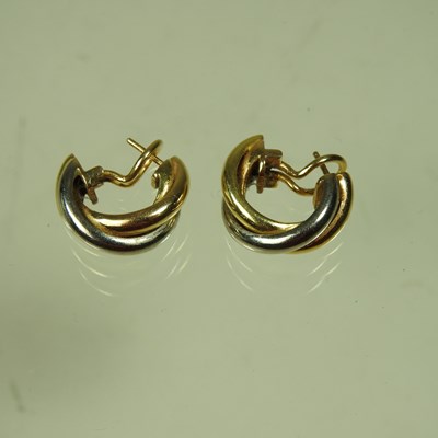 Lot 449 - A pair of Cartier 18 carat Trinity three...