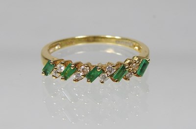 Lot 389 - An 18 carat gold baguette cut emerald and...