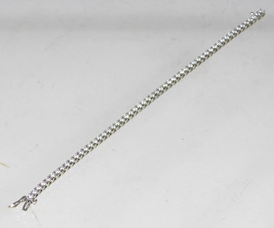 Lot 529 - An 18 carat white gold diamond set tennis...