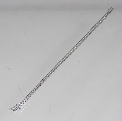 Lot 76 - A white gold diamond tennis bracelet, set with...