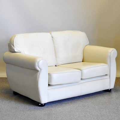 Lot 474 - A modern white leather upholstered two seater...