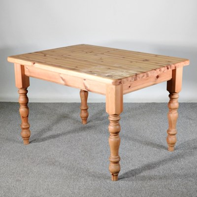 Lot 491 - A modern pine dining table, on turned legs