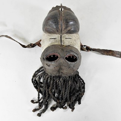 Lot 79 - An African carved wooden mask, probably...