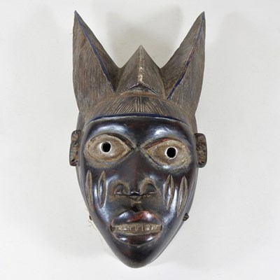 Lot 9 - An African carved wooden tribal mask, of...