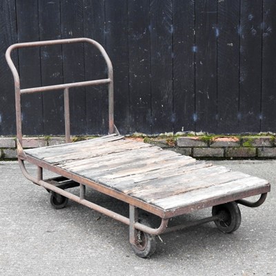 Lot 109 - A metal industrial trolley, with a wooden base