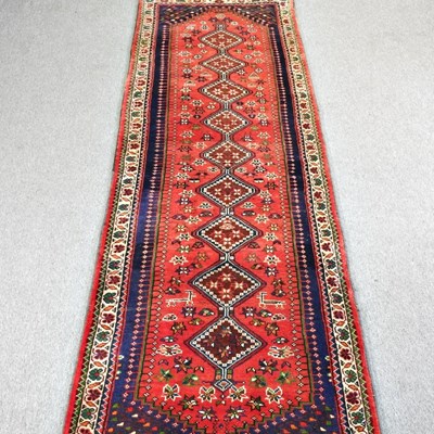 Lot 267 - A Persian runner, with a row of central...