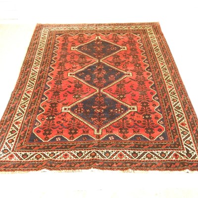 Lot 488 - A Persian shiraz carpet, having three central...