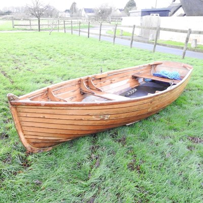 Lot 14 - A traditional wooden rowing boat, with a pair...