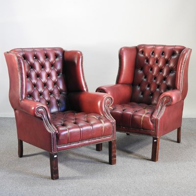 Lot 303 - A pair of red upholstered button back...