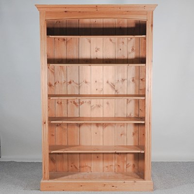 Lot 54 - A modern pine standing open bookcase, on a...