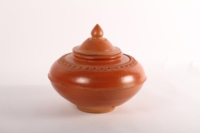 Lot 483 - A burnished earthenware jar, of squat globular...