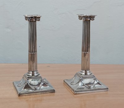 Lot 131 - A pair of George III silver candlesticks, each...