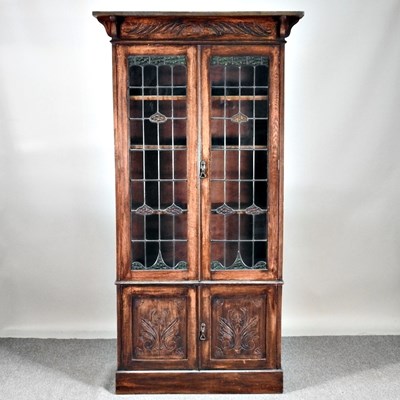 Lot 532 - An early 20th century lead glazed oak bookcase,...