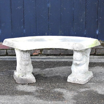 Lot 69 - A cast stone garden seat, of curved design