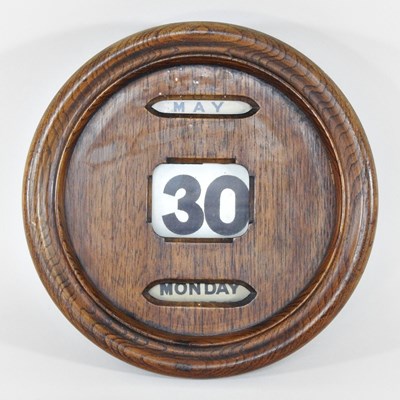 Lot 26 - An early 20th century oak cased wall calendar,...