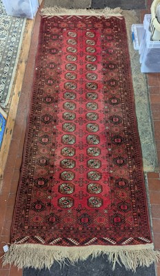 Lot 273 - A Bokhara runner, on a red ground, 103cm x 203cm