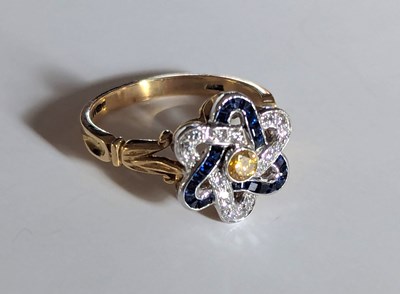 Lot 113 - An 18ct yellow gold blue and yellow sapphire...