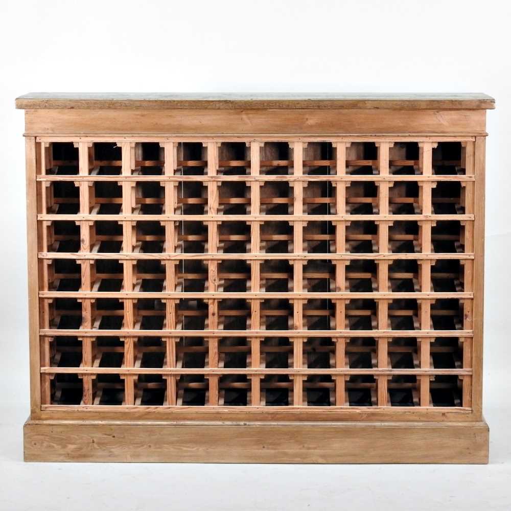 Lot 29 - A large hand made pine wine rack, on a plinth