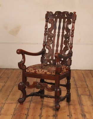 Lot 410 - A Carolean style oak armchair, having a padded...