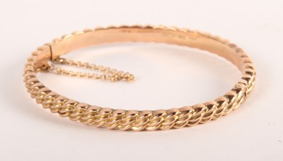 Lot 76 - A 9ct gold hinged bangle, 7.74g