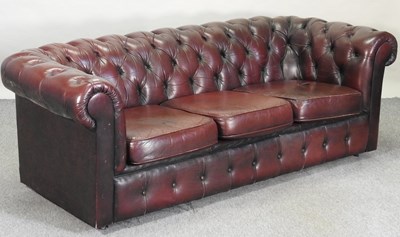 Lot 582 - A red upholstered chesterfield sofa