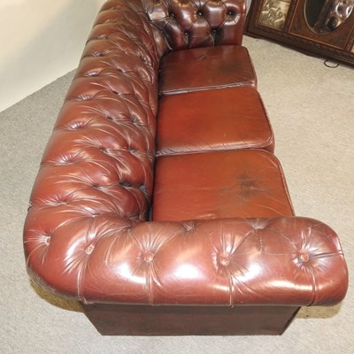 Lot 582 - A red upholstered chesterfield sofa