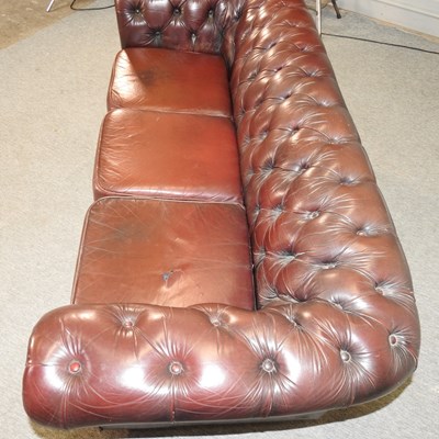 Lot 582 - A red upholstered chesterfield sofa