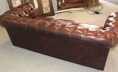 Lot 582 - A red upholstered chesterfield sofa