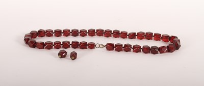 Lot 306 - A faceted faux cherry amber necklace, 90cm,...