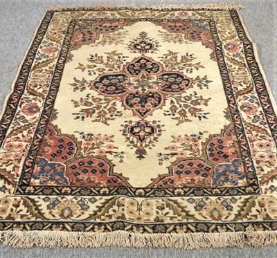 Lot 391 - A Persian style woollen rug, with a central medallion