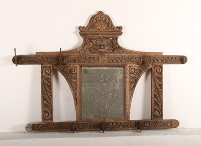 Lot 356 - A Victorian carved oak wall mirror, with hooks,...