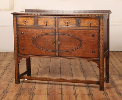 Lot 390 - A 1920s oak sideboard, having moulded...