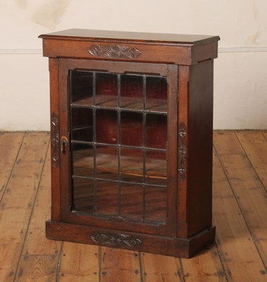 Lot 375 - A 1920s oak display cabinet, having a single...