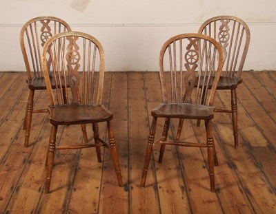 Lot 421 - A set of four elm seated wheelback chairs